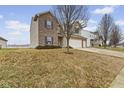 Charming two-story home featuring brick accents, a two-car garage, and a spacious front yard at 8547 S Tibbs Ave, Indianapolis, IN 46217