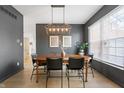 Elegant dining room with a stylish light fixture and dark accent wall at 8694 Emerald Blvd, McCordsville, IN 46055