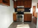 Functional kitchen featuring wood cabinets, stainless steel appliances, and tiled backsplash at 9150 Granville Ct, Indianapolis, IN 46229