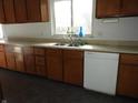 Kitchen featuring wood cabinets, a stainless steel sink, and a dishwasher at 9150 Granville Ct, Indianapolis, IN 46229