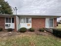 A red brick exterior with slider door and compact landscaping at 931 W Mckay Rd, Shelbyville, IN 46176