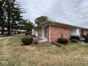 A charming brick home with a small patio and lawn at 931 W Mckay Rd, Shelbyville, IN 46176