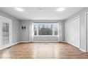 Spacious living room features hardwood floors, bright windows, and ample closet space at 1313 Oakwood Trl, Indianapolis, IN 46260