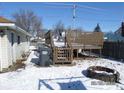Backyard features a wooden deck area and fire pit, perfect for relaxing and outdoor enjoyment at 1524 S K St, Elwood, IN 46036