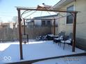 Snow covered patio, enhanced by string lights, providing a serene and inviting outdoor space at 1524 S K St, Elwood, IN 46036