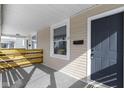 Inviting front porch featuring a gray front door and natural wood railing at 17 Parkview Ave, Indianapolis, IN 46201