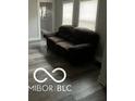 Living room featuring a brown couch and stylish gray laminate floors at 2309 N Dearborn St, Indianapolis, IN 46218