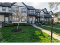 Attractive townhome exterior with blue trim, well-kept lawn, and inviting front entrance at 2357 Central Ave, Indianapolis, IN 46205