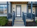 Inviting front porch with blue trim and steps leading to the entrance door with house number at 2357 Central Ave, Indianapolis, IN 46205