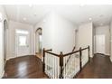 Bright foyer showcasing dark hardwood floors and white trim with a staircase at 2564 Tangleridge Ln, Brownsburg, IN 46112