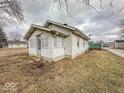 Side view of home showing the exterior, with a small porch and neutral siding at 3049 Foltz St, Indianapolis, IN 46241