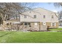Two-story townhome featuring a brick facade, white siding, a fenced yard, and a well-maintained lawn at 3986 Braddock Rd, Indianapolis, IN 46268