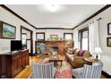 Cozy living room with a brick fireplace, hardwood floors, and lots of natural light at 4029 Broadway St, Indianapolis, IN 46205