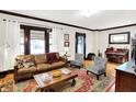 Bright and airy living room featuring hardwood floors, stylish furniture, and large windows at 4029 Broadway St, Indianapolis, IN 46205