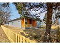 View of charming home with siding and a cute front porch protected by a picket fence and mature landscaping at 4804 Brouse Ave, Indianapolis, IN 46205