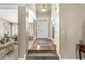 Inviting foyer with hardwood floors and an elegant staircase leading to the upper level at 4947 Cherryhill Ct, Indianapolis, IN 46254