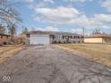 Charming brick and stone home featuring an attached garage and long driveway at 5312 Daniel Dr, Indianapolis, IN 46226