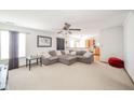 Open concept living room with a comfortable sofa, seamlessly connecting to the dining and kitchen areas at 5347 Rolling River Ct, Indianapolis, IN 46221