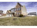 Charming two-story home with a well-manicured lawn and inviting curb appeal on a sunny day at 5810 Grand Ave, Plainfield, IN 46168