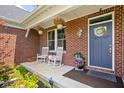 Inviting front porch with rocking chairs and decorative plants at 6504 W May Apple Dr, McCordsville, IN 46055