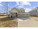 Inviting two-story home with attached two car garage, covered porch and well-kept landscaping at 6705 Park Grove Blvd, Whitestown, IN 46075