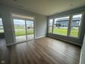 Living room featuring hardwood floors, lots of natural light, and a sliding glass door at 7227 Bailow Ct, McCordsville, IN 46055