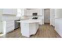 A bright kitchen with an island, stainless steel appliances, white cabinets, and tile backsplash at 815 Allandale Ave, Westfield, IN 46074