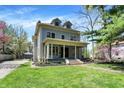 Charming two-story home with a welcoming front porch and well-manicured lawn at 828 Woodruff Place Middle Dr, Indianapolis, IN 46201