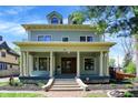 Beautiful two-story home boasts a welcoming front porch with classic architectural details at 828 Woodruff Place Middle Dr, Indianapolis, IN 46201