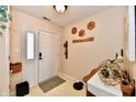 Welcoming foyer featuring tile floors, white door with glass and neutral wall paint at 9247 Backwater Dr, Indianapolis, IN 46250