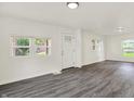 Bright living room with fresh paint, modern gray floors, and three big windows at 952 N Concord St, Indianapolis, IN 46222