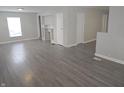 Open-concept living room with built-ins, wood-look floors, and easy access to other rooms at 952 N Concord St, Indianapolis, IN 46222
