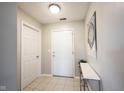 Bright entryway features neutral tile flooring, fresh white trim, and a convenient coat closet at 9667 Overcrest Dr, Fishers, IN 46037