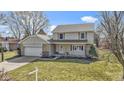 Inviting two-story home featuring a stone-accented garage and a pleasant front yard at 101 Aspen Way, Noblesville, IN 46062