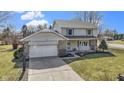Attractive two-story home with a two-car garage, stone veneer, and a well-kept front lawn at 101 Aspen Way, Noblesville, IN 46062