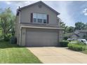Inviting two-story house showcasing a neat front lawn and a practical two-car garage, in a Gathering-friendly neighborhood at 10419 Dark Star Dr, Indianapolis, IN 46234