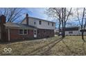View of the backyard and back exterior, showing a mix of brick and siding at 11506 Rolling Springs Dr, Carmel, IN 46033