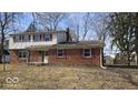 Traditional two-story home with brick facade, red shutters, and a cozy front porch at 11506 Rolling Springs Dr, Carmel, IN 46033