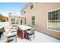Back patio with a large outdoor dining table and chairs, perfect for entertaining guests at 1226 Siena Dr, Greenwood, IN 46143