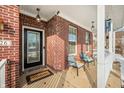 Inviting front porch featuring brick columns, a decorative welcome mat, and comfortable seating at 1226 Siena Dr, Greenwood, IN 46143