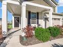 Inviting front porch with cozy seating, complemented by lush landscaping and a welcoming entrance at 12650 Sunrise Dr, Noblesville, IN 46060