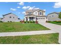 Charming two-story home showcasing a spacious lawn and a well-maintained exterior on a sunny day at 12650 Sunrise Dr, Noblesville, IN 46060