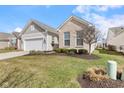 This home has a two-car garage, a manicured lawn, and professional landscaping at 12819 Bardolino Dr, Fishers, IN 46037