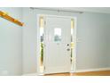 Bright foyer with a white front door, coat rack and ample natural light at 13060 Wembly Cir, Carmel, IN 46033