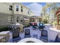 An outdoor patio area with a built-in grill, seating, and a cozy fire pit for entertaining at 14335 Stella Ct, Fishers, IN 46040
