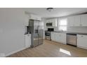 Renovated kitchen featuring stainless steel appliances, white cabinetry, and new flooring at 2014 Barth Ave, Indianapolis, IN 46203