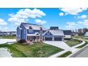 Expansive aerial view of a home with a large yard, neighborhood, and three-car garage at 20451 Chatham Hills Blvd, Westfield, IN 46074