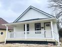 Charming renovated one-story home featuring a covered porch and fresh white exterior at 2137 Napoleon St, Indianapolis, IN 46203