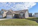 Beautiful single-story home with brick accents, attached garage, and a well-maintained front yard in a lovely neighborhood at 293 Carrick Glen Blvd, Pendleton, IN 46064