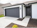 Attractive single-story home featuring a black garage door and white siding at 3261 W Keepsake Ln, Monrovia, IN 46157